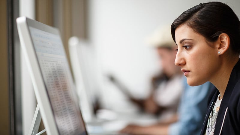 Woman looking a computer monitor.