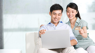 Portrait of a couple online shopping from home
