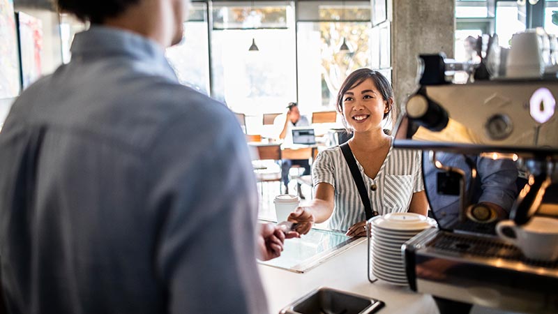 Lady paying at a counter