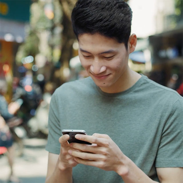 Guy using phone in the street