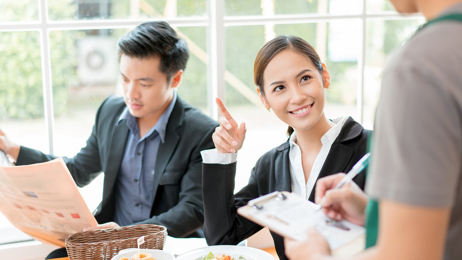 Waiter taking orders from lady