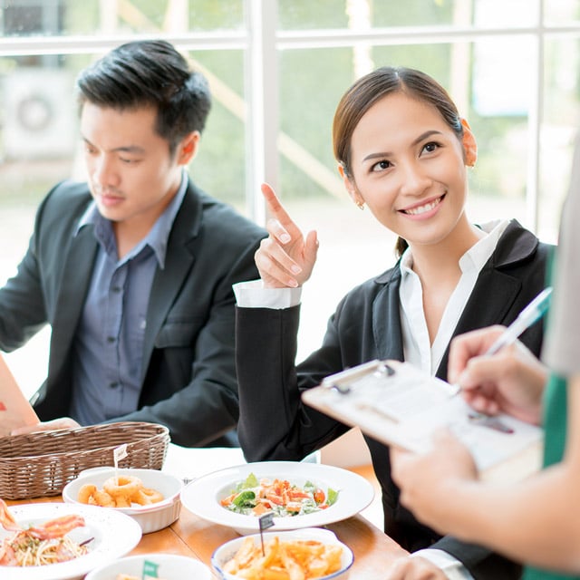 Waiter taking orders from lady